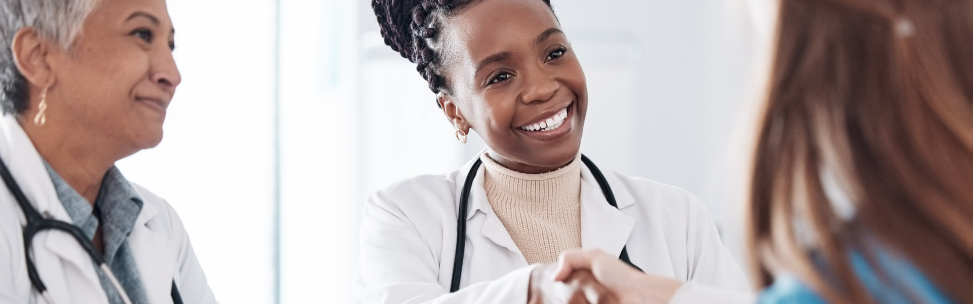 female doctor doing a handshake